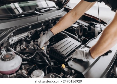 Troubleshooting process. Auto mechanic working in garage. Repair service. - Powered by Shutterstock