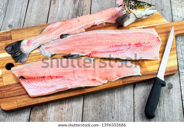 \
Trout fillets on cutting board with filleting\
knife