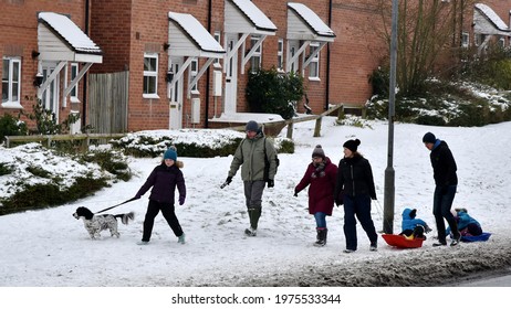 Trowbridge, UK - March 2, 2018: People Walk Through Snow Pulling Children In Sledges. The Entire British Isles Have Seen Heavy Winter Snow Storms.