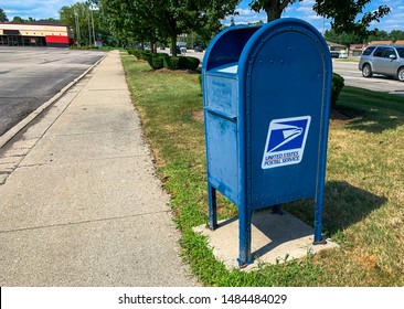 TROY, MICHIGAN - AUGUST 13, 2019: USPS Mailbox Beside Sidewalk