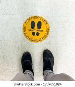 Troy, Michigan, USA - 16  May 2020 :Practice Social Distancing Sign On The Ground At Grocery Store Supermarket During Outbreak Of Novel Coronavirus COVID-19 Pandemic In United States