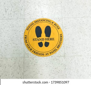 Troy, Michigan, USA - 16  May 2020 :Practice Social Distancing Sign On The Ground At Grocery Store Supermarket During Outbreak Of Novel Coronavirus COVID-19 Pandemic In United States