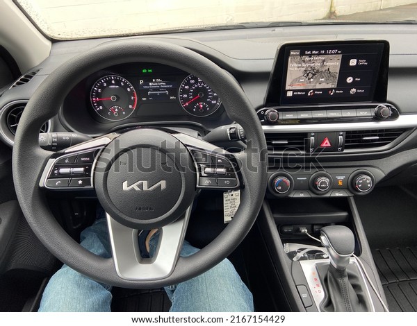 Troy, Ohio - March 19, 2022: Interior of a new\
Kia Forte Sedan with Apple Car\
Play.