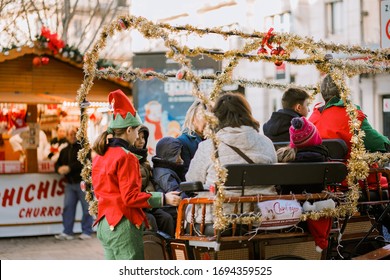Troyes, France -24/12/2019: Tourists on the Christmas Work Horses Drawn Carriage 