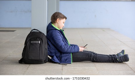 Truancy Concept, Young Boy Staying Away From The School And Playing Games On The Mobile, Smartphone, Absence From School