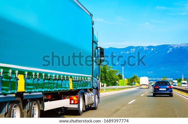 Truck in the asphalt road in Poland. Lorry\
transport delivering some freight\
cargo.