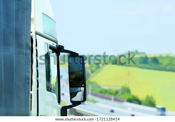 Truck, back view, traffic on the highway,\
beautiful hill landscape,\
pastures