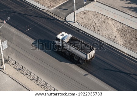 Truck with a breakstone on a road in the city during road construction work.