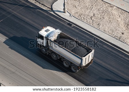 Truck with a breakstone on a road in the city during road construction work.