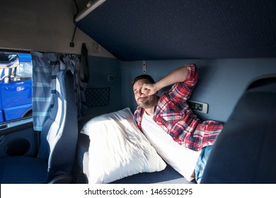 Truck cabin interior with driver sleeping in bed. Truck driver waking up in his cabin after a long ride. Trucker lifestyle.