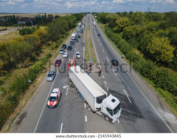 The truck and the car\
collided on the highway. Strong accident. Traffic accidents on the\
road. View from above. Traffic jam on the road. DNIPRO, UKRAINE –\
August 12, 2020