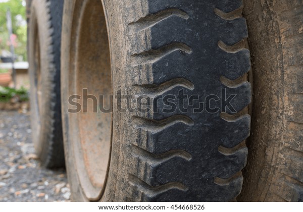 Truck car tire\
with soil dust so heavy and\
big