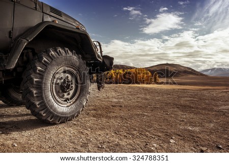 Truck car wheel on offroad steppe adventure trail