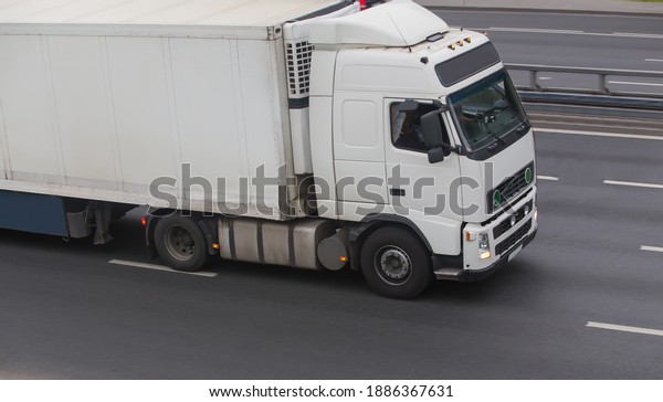 Truck carries goods on a\
city street