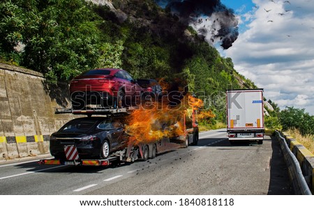 The truck carrying cars caught fire. Trailer carrying cars. Fire