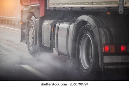 Truck chassis and wheels on a wet road in rainy weather, close-up. Safety concept and tire grip on wet roads, braking distances under emergency braking, close-up