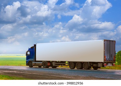 truck with the container goes on the country highway
