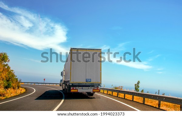 Truck with container on highway, cargo\
transportation concept.