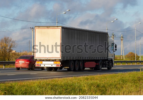 Truck with container on\
highway, cargo transportation concept. Shaving effect. Truck\
transportation. 