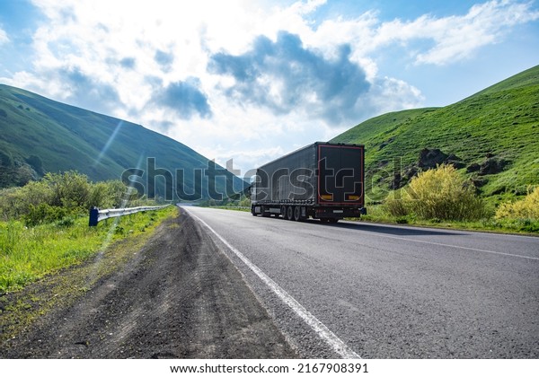 Truck with container on highway, cargo\
transportation concept.