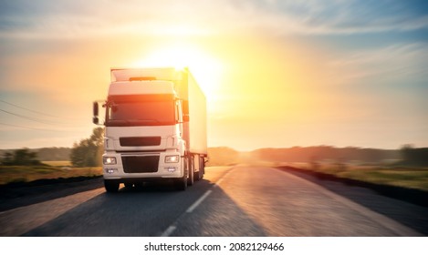 Truck with container on highway with sun light. Concept cargo transportation banner. Blur move effect.