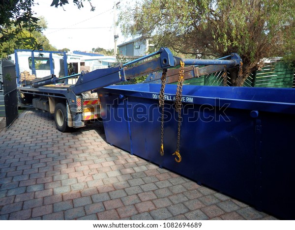Truck delivering a empty\
waste skip