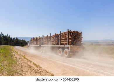 Truck Dirt Road Wood 
Truck Vehicle Transporting Cut Forest Tree Wood Logs On Dirt Road Mountain Countryside.