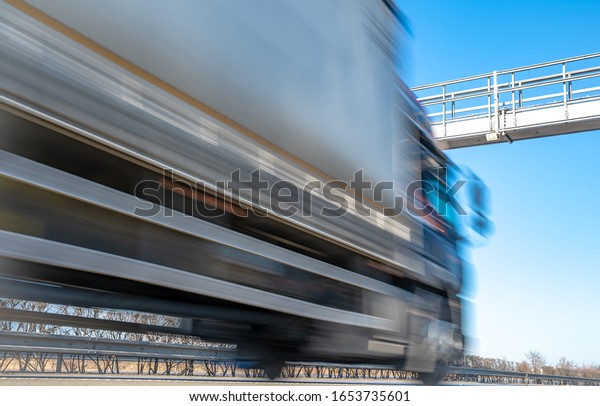 truck drive through the\
highway through the toll gate, toll charges, blurred motion in the\
image