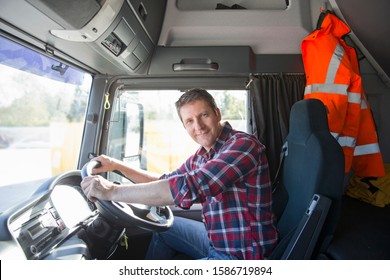Truck driver in cab of semi-truck