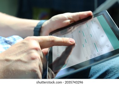 Truck Driver Checking Electronic Logbooks On A Tablet