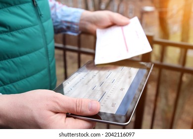 Truck Driver Checking Electronic Logbooks On A Tablet