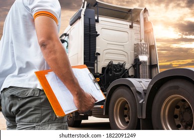 Truck Driver Is Checking The Semi Truck's Engine Maintenance Checklist. Mechanic Repairman Auto Service Shop.Lorry. Inspection Truck Wheels Tires Safety Driving. Shipping Cargo Freight Truck Transport