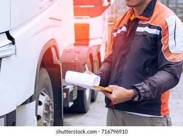 Truck Driver Is Checking The Semi Truck's Maintenance Checklist. Lorry Driver. Inspection Truck 
Wheels Safety Driving. Shipping Cargo Freight Truck Transport.	
