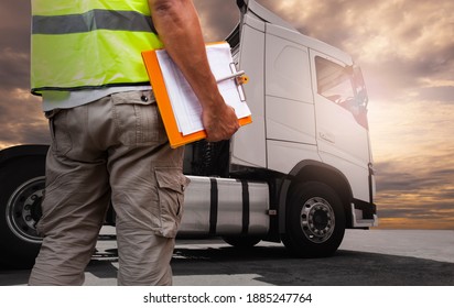 Truck Driver is Checking the Truck's Safety Maintenance Checklist. Lorry. Inspection Semi Truck Wheels and Tires. Freight Truck Transportation.