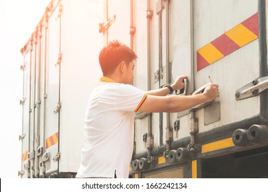 Truck Driver Is Closing The Container Door. Steel Door Security Lock Of A Truck, Freight Industry Logistics, Transport