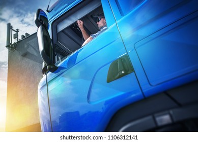 Truck Driver Contract. Young Caucasian Men In His 30s Inside His Brand New Blue Semi Truck.