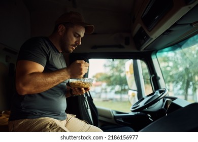 Truck Driver Eating Lunch In Vehicle Cabin. 