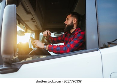 Truck Driver Fastens Seatbelt  And Preparing For The Next Destination.