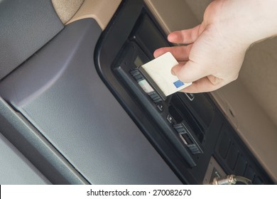 Truck Driver Is Inserting Tachograph Card To The Device Inside The Truck Cab.