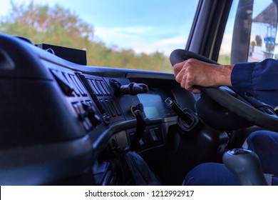 Truck Driver Keeps Driving With Hands,The Man Behind Semi Truck Steering Wheel.