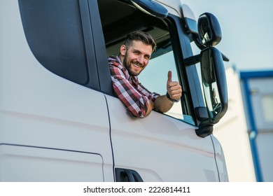 Truck driver sitting in his truck showing thumbs up. Trucker occupation. transportation services. - Shutterstock ID 2226814411