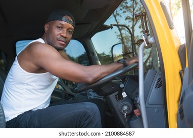 Truck Driver Smiling Confident In Insurance Cargo Lorry In Long Transportation And Delivery Business. Young African-American Man Training Driving Commercial Driver License At Truck Driving School.