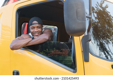 Truck Driver Smiling Confident In Insurance Cargo Lorry In Long Transportation And Delivery Business. Young African-American Man Training Driving Commercial Driver License At Truck Driving School.