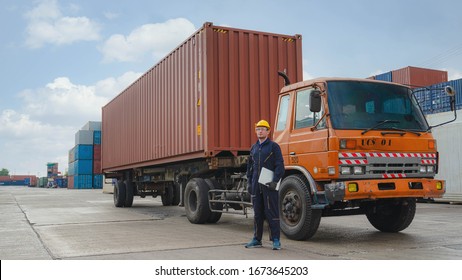 truck driver standing by container truck at containers yard and cargo
