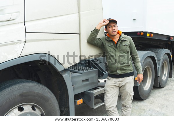 truck driver stands beside the semi-trailer\
truck, freight industry truck\
transport.