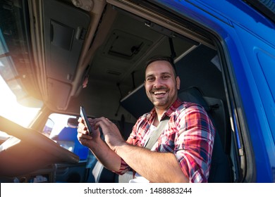 Truck Driver With Tablet Using GPS Navigation For His Route. Transportation Services.