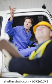 Truck Driver Talking To Worker