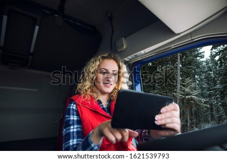 Similar – Image, Stock Photo Female delivery driver using barcode scanner checking pacel in a van in the city