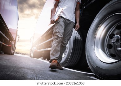 Truck Driver Walking And Checking A Truck Wheels And Tires. Mechanic Repairman Auto Service Shop. Inspection Maintenance And Safety Truck Driving. Industry Freight Truck Transport.
