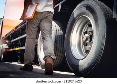 Truck Driver Walking's Checking The Truck's Safety Maintenance Checklist. Repairman Auto Service Shop. Lorry Inspection Semi Truck Wheels And Tires. Freight Truck Transportation.	